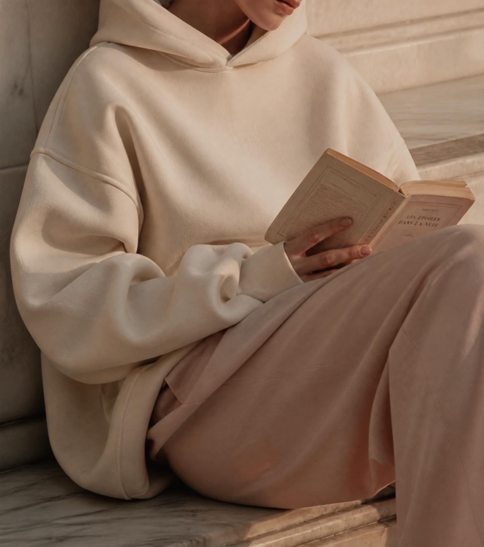 Editorial portrait in cream hoodie